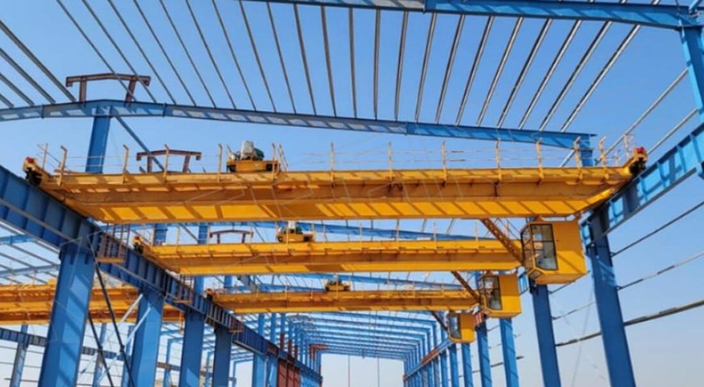 Double girder overhead bridge cranes on runway beams in a plant